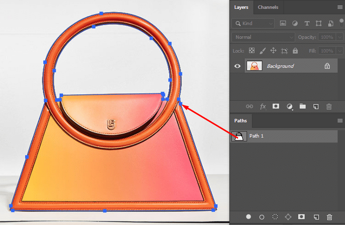 Zooming in and using the Pen Tool to carefully create a clipping path around the object in Photoshop.